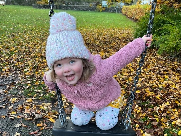 Image of Erin playing on the swings Image of Erin playing on the swings