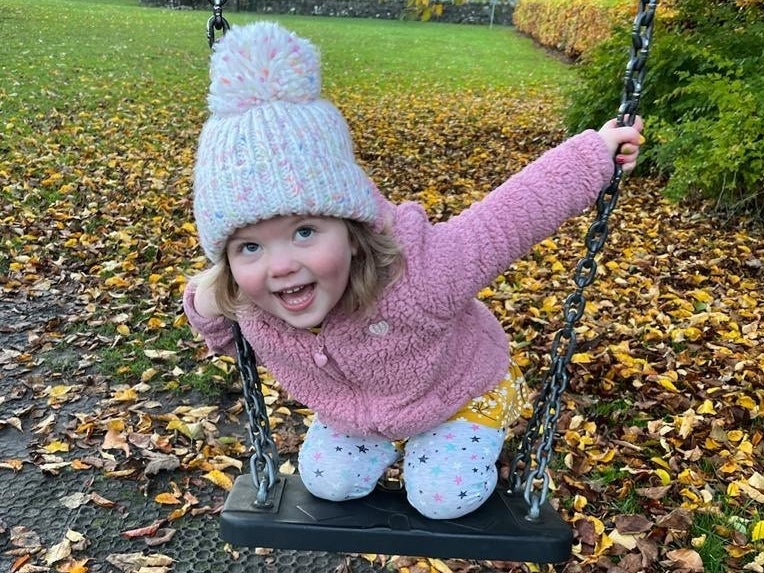 Image of Erin playing on the swings Image of Erin playing on the swings