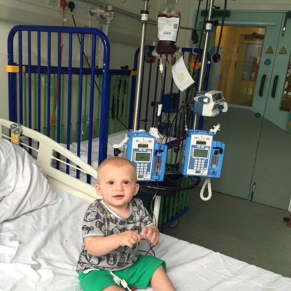 Alfie sitting on a hospital bed surrounded by machines Alfie sitting on a hospital bed surrounded by machines