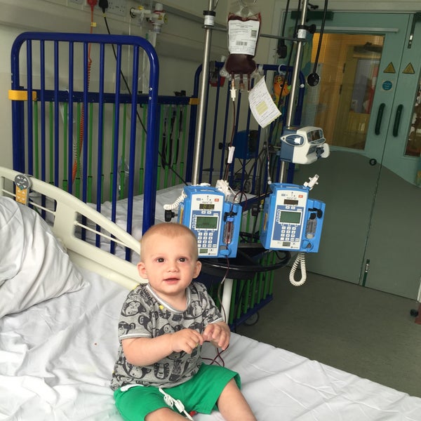 Alfie sitting on a hospital bed surrounded by machines  Alfie sitting on a hospital bed surrounded by machines