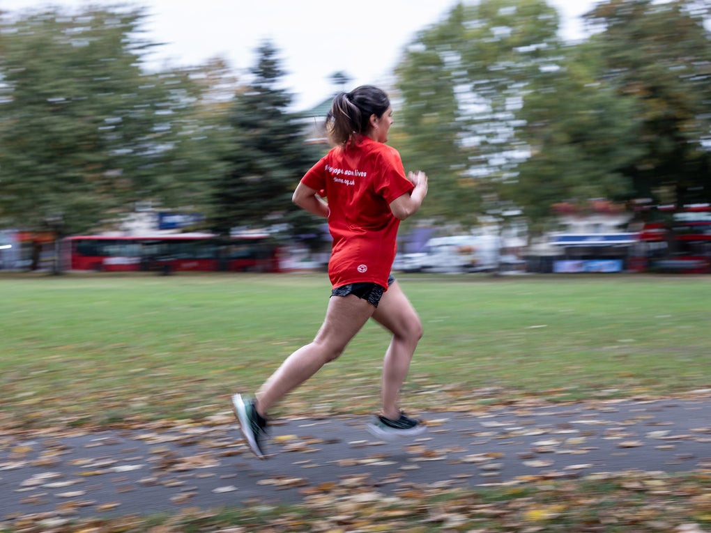 Woman running in red top Woman running in red top