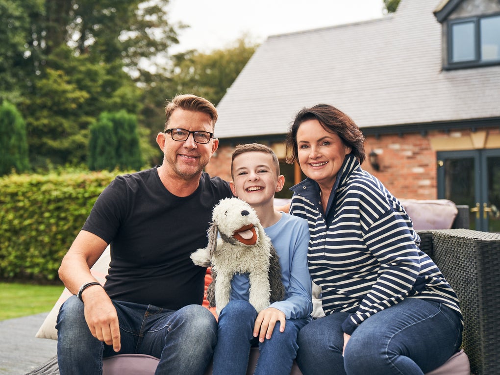 Finn with his parents, Paul and Jo, sitting in their garden Finn with his parents, Paul and Jo, sitting in their garden