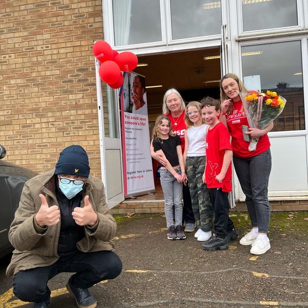 Terry smiling at the Camera with his family Terry smiling at the Camera with his family