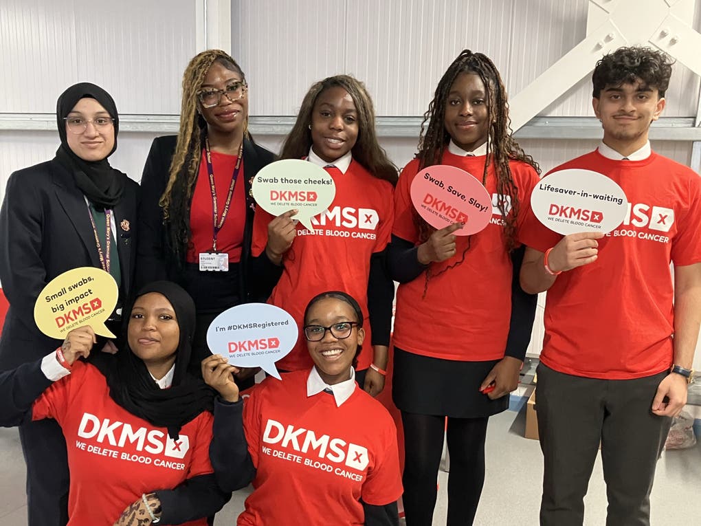 School students taking part in the Generation Lifesaver young donor registration initiative pose for a photograph with DKMS UK branded speech bubble props. School students taking part in the Generation Lifesaver young donor registration initiative pose for a photograph with DKMS UK branded speech bubble props.