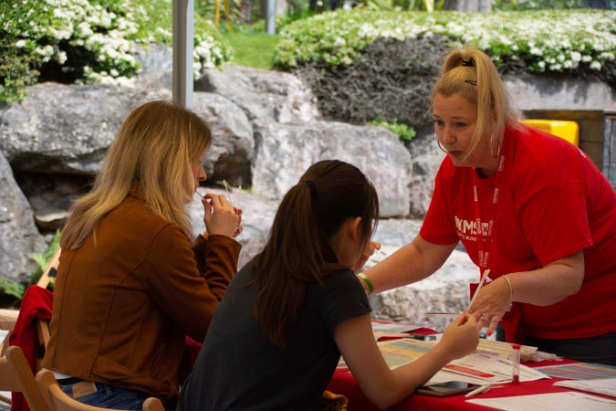DKMS manager registrering two potential donors at an outdoor recruitment event