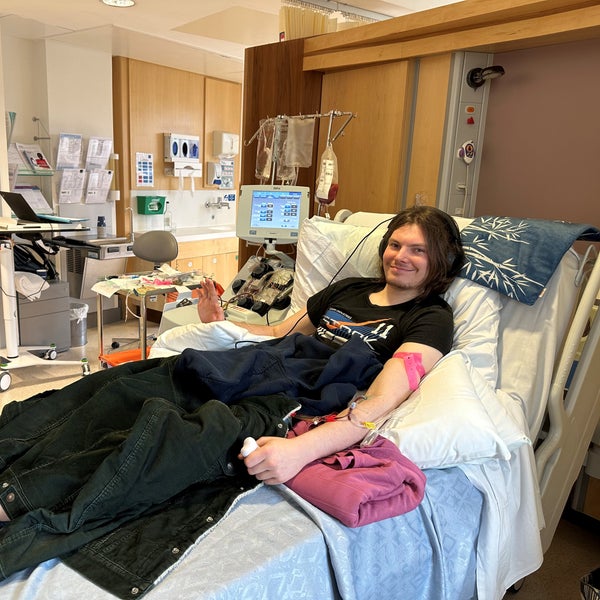 Man lying on a hospital bed and smiling at Camera Man lying on a hospital bed and smiling at Camera