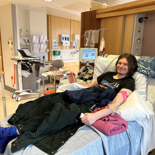 Man lying on a hospital bed and smiling at Camera Man lying on a hospital bed and smiling at Camera