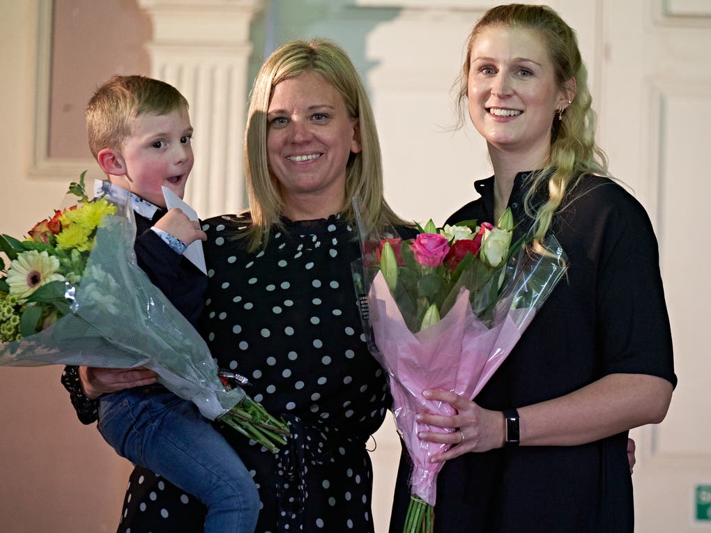 Alfie with his Mum and Christin holding flowers when they met for the first time Alfie with his Mum and Christin holding flowers when they met for the first time