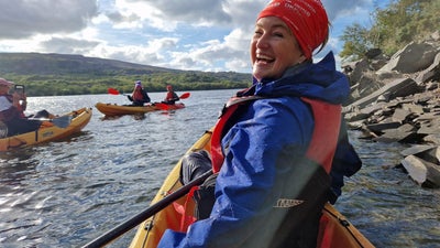 Claire Morgan-Hughees kayaking on a lake