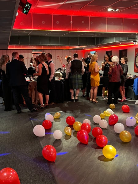 DKMS Scotland Gala celebrations in progress with many red yellow and white ballons in the foreground