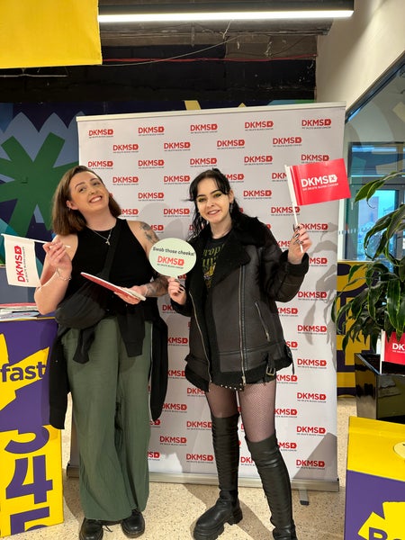 Two guests smiling at a DKMS event