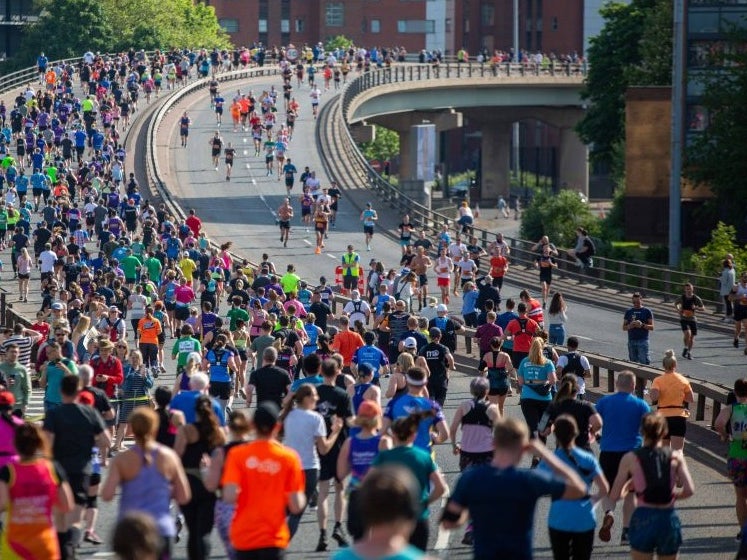 Runners in the Great Manchester Run crossing a bridge Runners in the Great Manchester Run crossing a bridge