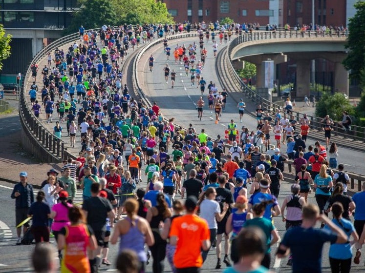 Runners in the Great Manchester Run crossing a bridge Runners in the Great Manchester Run crossing a bridge