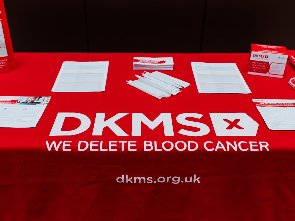 Table with a red cloth and the DKMS logo on Table with a red cloth and the DKMS logo on