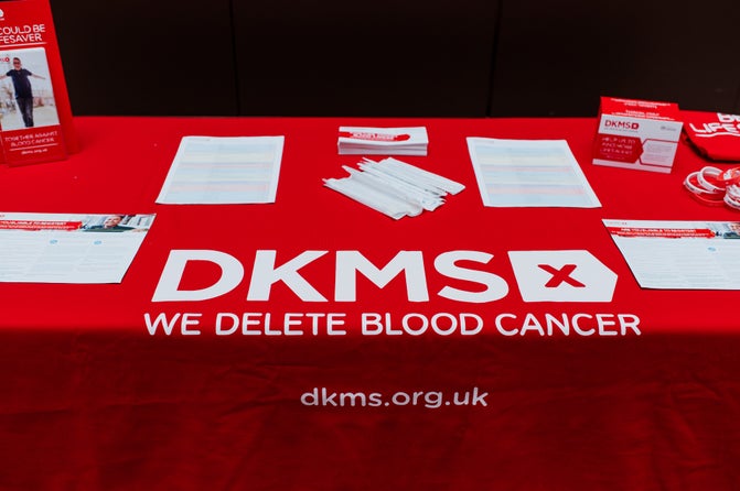 Table with a red cloth and the DKMS logo on 
