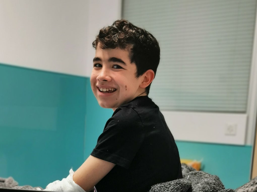 Archie sitting on bed smiling. Archie sitting on bed smiling.