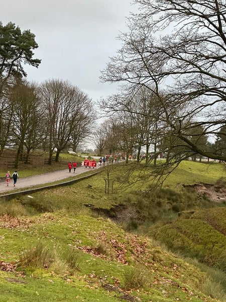 Competitors inthe distance running along a beautiful country lane