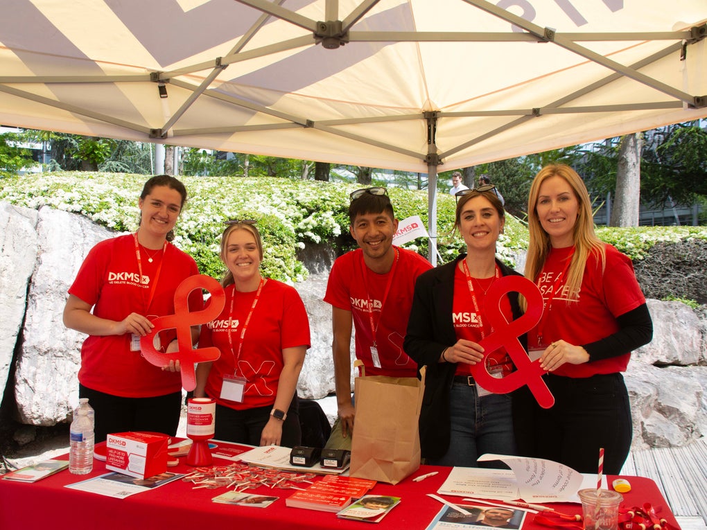 Ian (centre) with four DKMS colleagues wearing red DKMS t-shirts at a donor drive in May 2023 Ian (centre) with four DKMS colleagues wearing red DKMS t-shirts at a donor drive in May 2023
