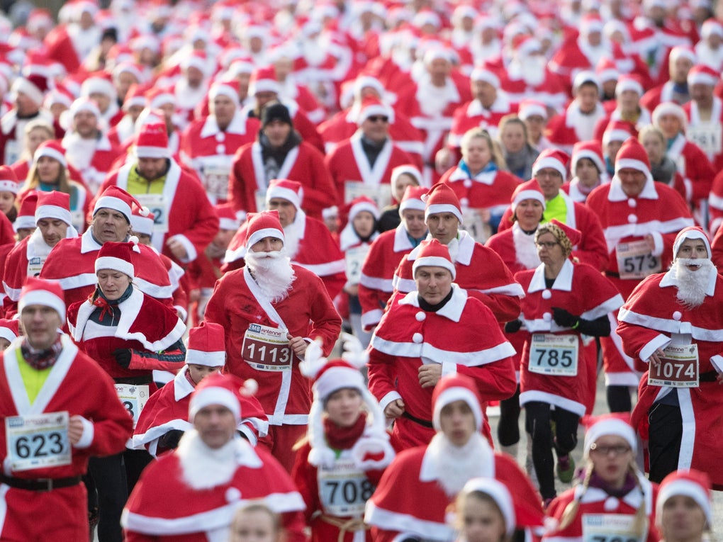 Lots of people dressed in santa suits running Lots of people dressed in santa suits running