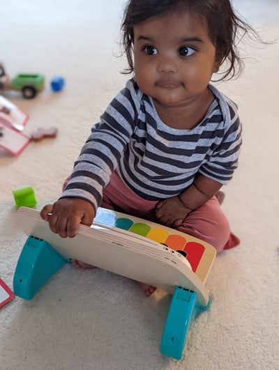 Image of Evie playing with her toys