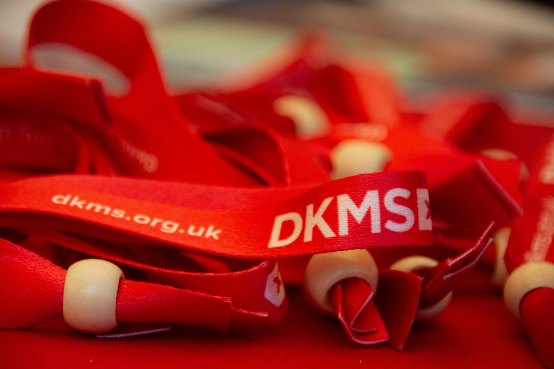 DKMS ribbon bracelets displaying website URL