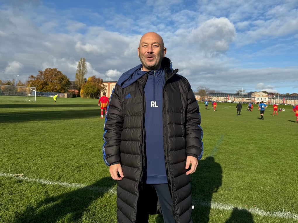 Elderly white man smiling on a football field Elderly white man smiling on a football field