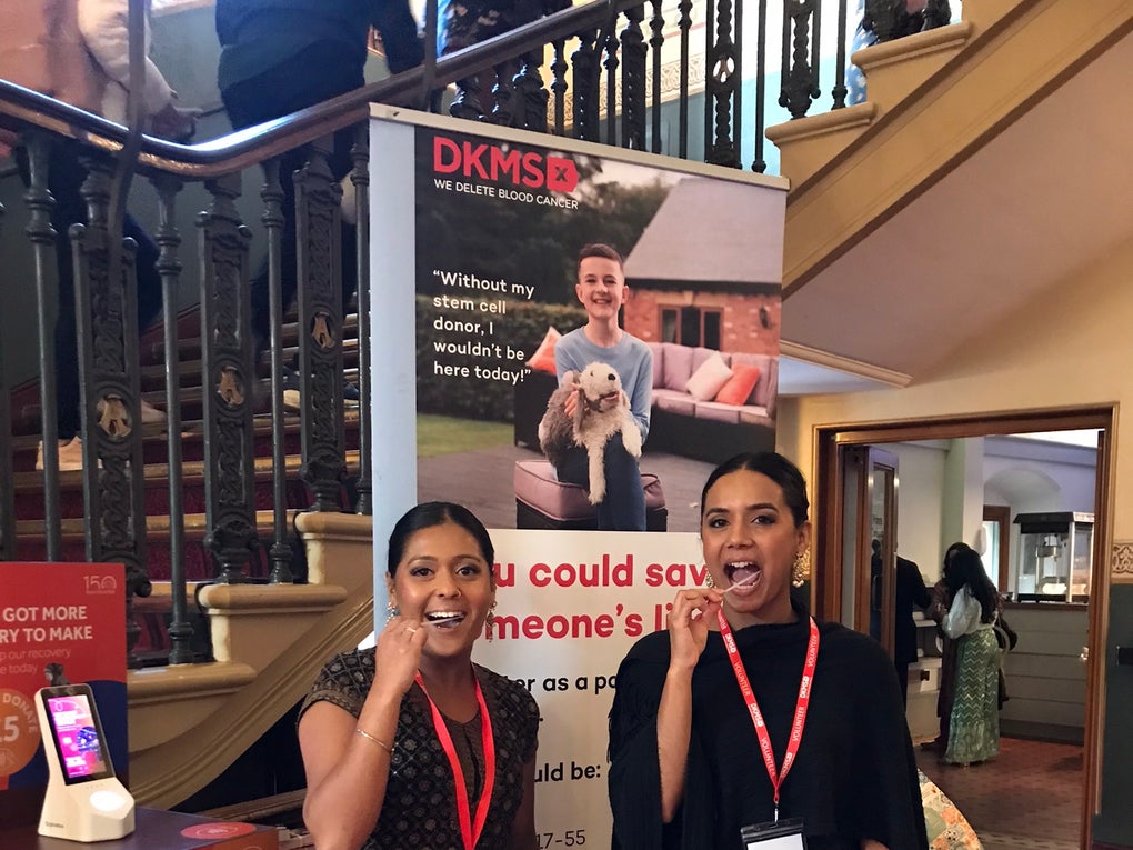 Two Asian women swabbing at a dkms registration event Two Asian women swabbing at a dkms registration event