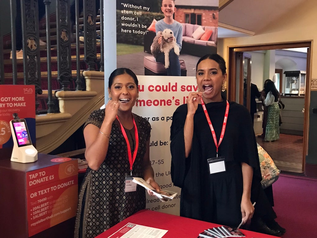 Two Asian women swabbing at a dkms registration event Two Asian women swabbing at a dkms registration event