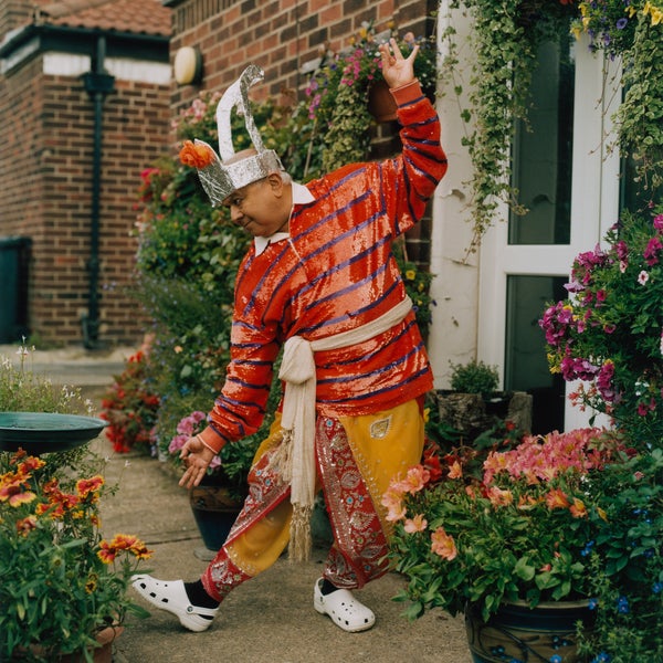 South Asian man wearing colourful clothes and a silver headdress South Asian man wearing colourful clothes and a silver headdress