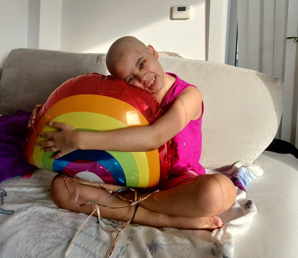Aashna holding a rainbow balloon