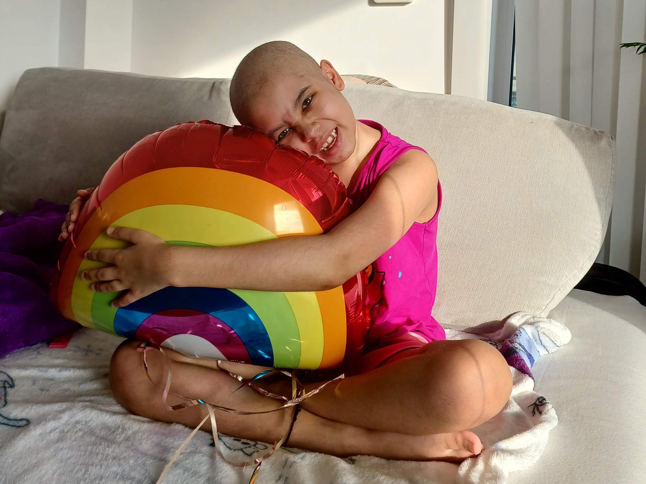 Aashna holding a rainbow balloon