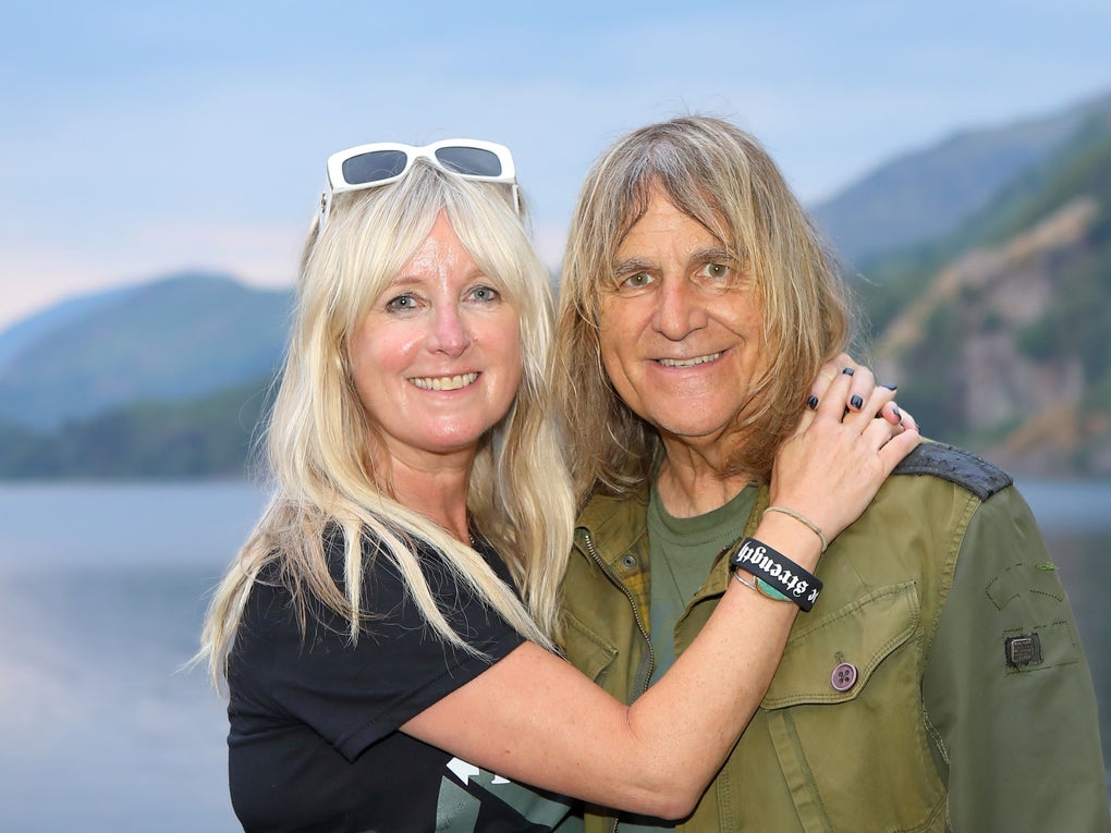 A middle aged white woman and man in front of a lake A middle aged white woman and man in front of a lake