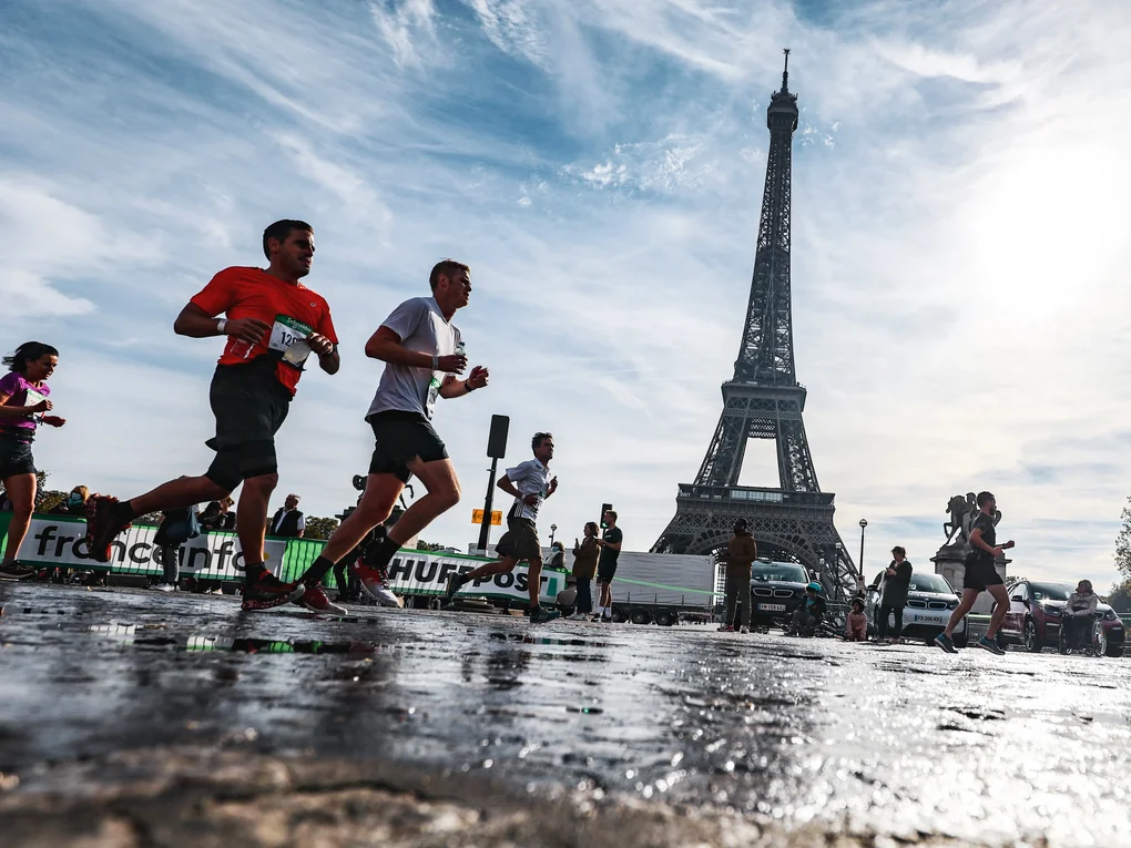 Several runners with the Eiffel Tower in the background Several runners with the Eiffel Tower in the background