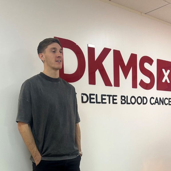 Jimmy Dunne at the DKMS UK office standing by the Corporate signage Jimmy Dunne at the DKMS UK office standing by the Corporate signage