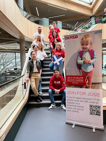 DKMS volunteers smiling on a staircase
