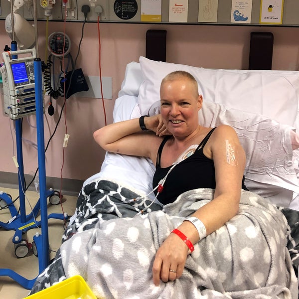 Elderly white woman lying in hospital bed and smiling connected to tubes Elderly white woman lying in hospital bed and smiling connected to tubes