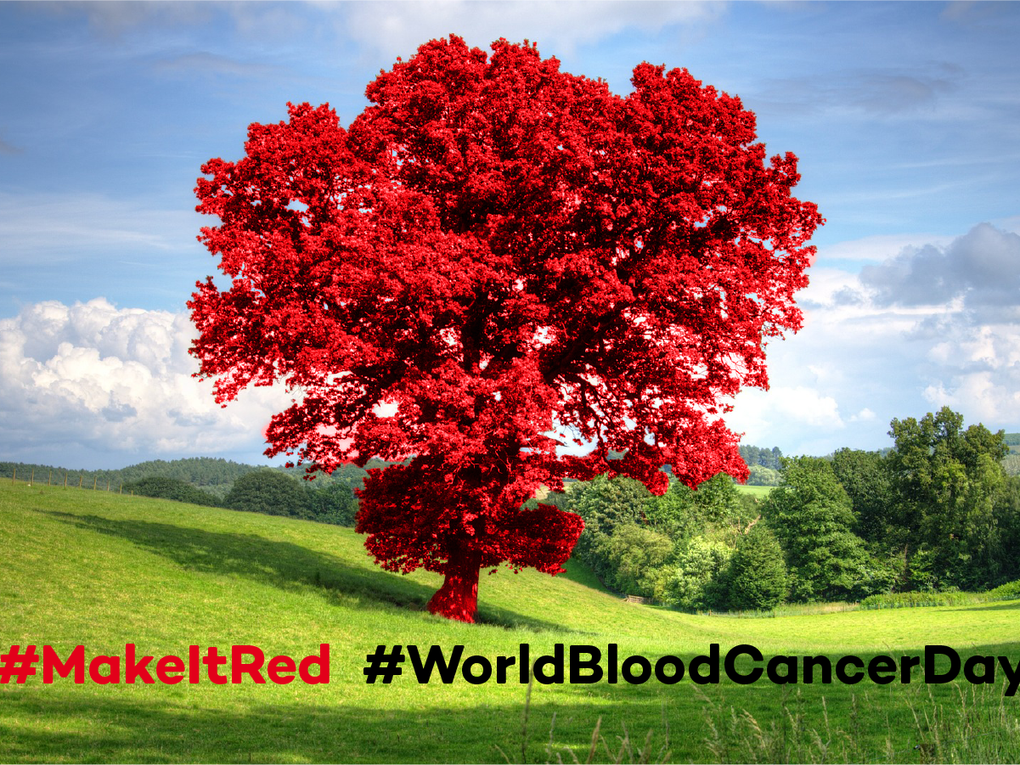 Red tree standing in a green field Red tree standing in a green field