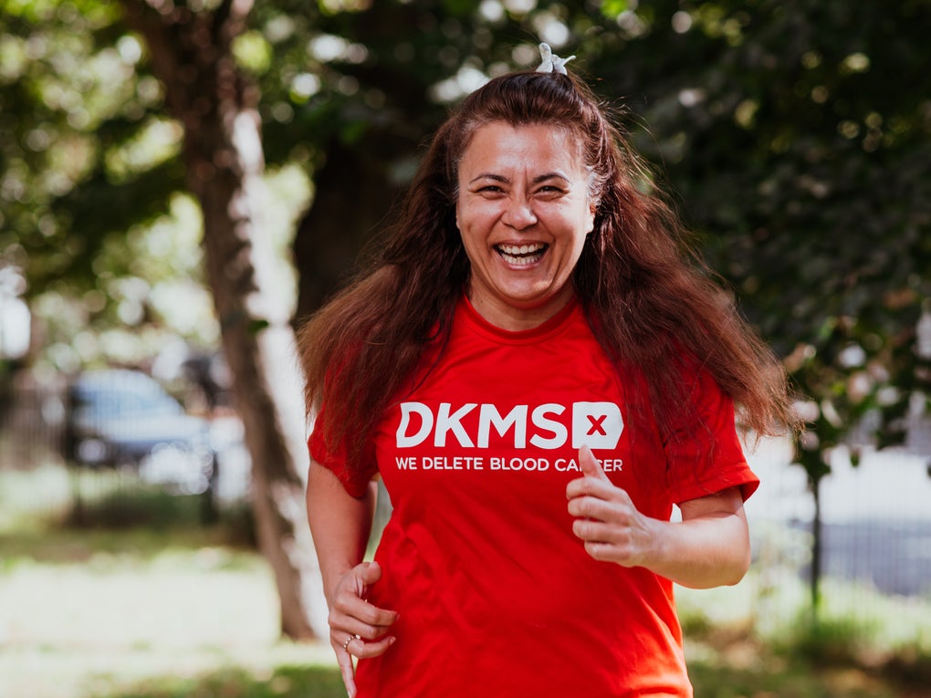 Woman running in her DKMS top Woman running in her DKMS top