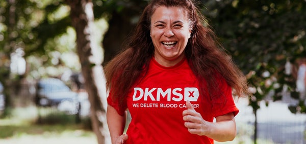 Woman running in her DKMS top