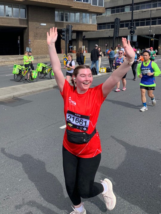Katie in DKMS top cheering as she runs
