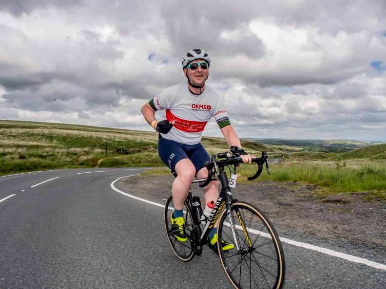 Image of man cycling in a DKMS top Image of man cycling in a DKMS top