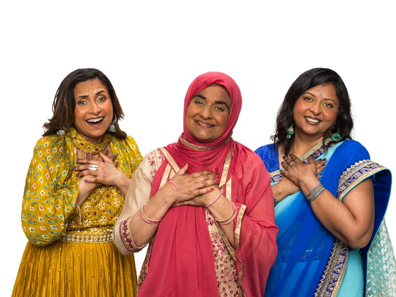 Three middled aged Asian women in sarees smiling Three middled aged Asian women in sarees smiling
