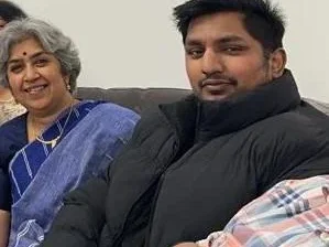 Mum and son sitting on sofa smiling Mum and son sitting on sofa smiling