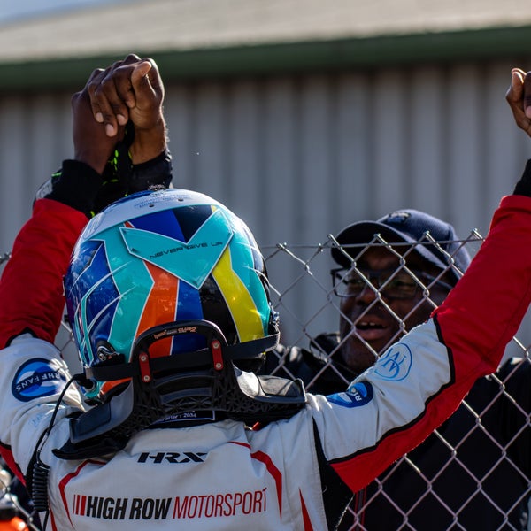 Cecil from Rochdale and his son embracing and holding hands over the fence after a motocross race Cecil from Rochdale and his son embracing and holding hands over the fence after a motocross race
