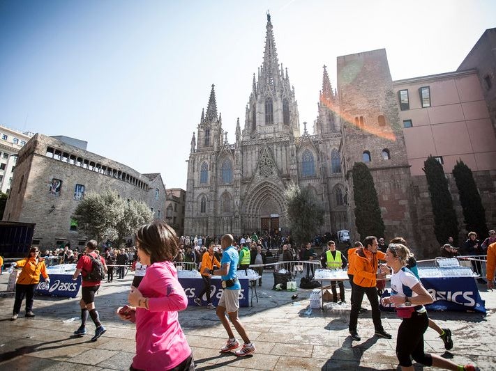Runners in race in Barcelona, passing by historic buildings Runners in race in Barcelona, passing by historic buildings