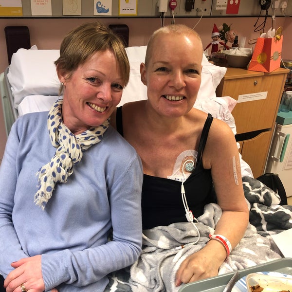 Two elderly white women smiling with one on the hospital bed Two elderly white women smiling with one on the hospital bed