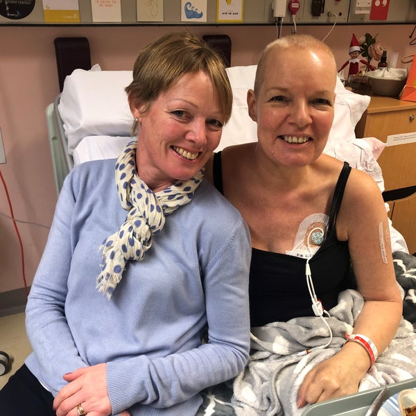 Two elderly white women smiling with one on the hospital bed Two elderly white women smiling with one on the hospital bed