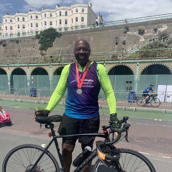 Paul Smith smiling after the Marathon holding his bike Paul Smith smiling after the Marathon holding his bike
