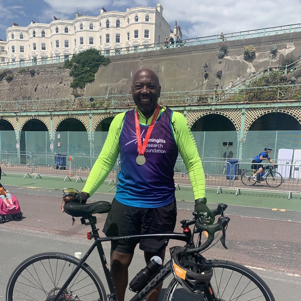 Paul Smith smiling after the Marathon holding his bike Paul Smith smiling after the Marathon holding his bike