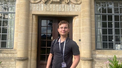 Zac standing in front of St Ann's College, Oxford
